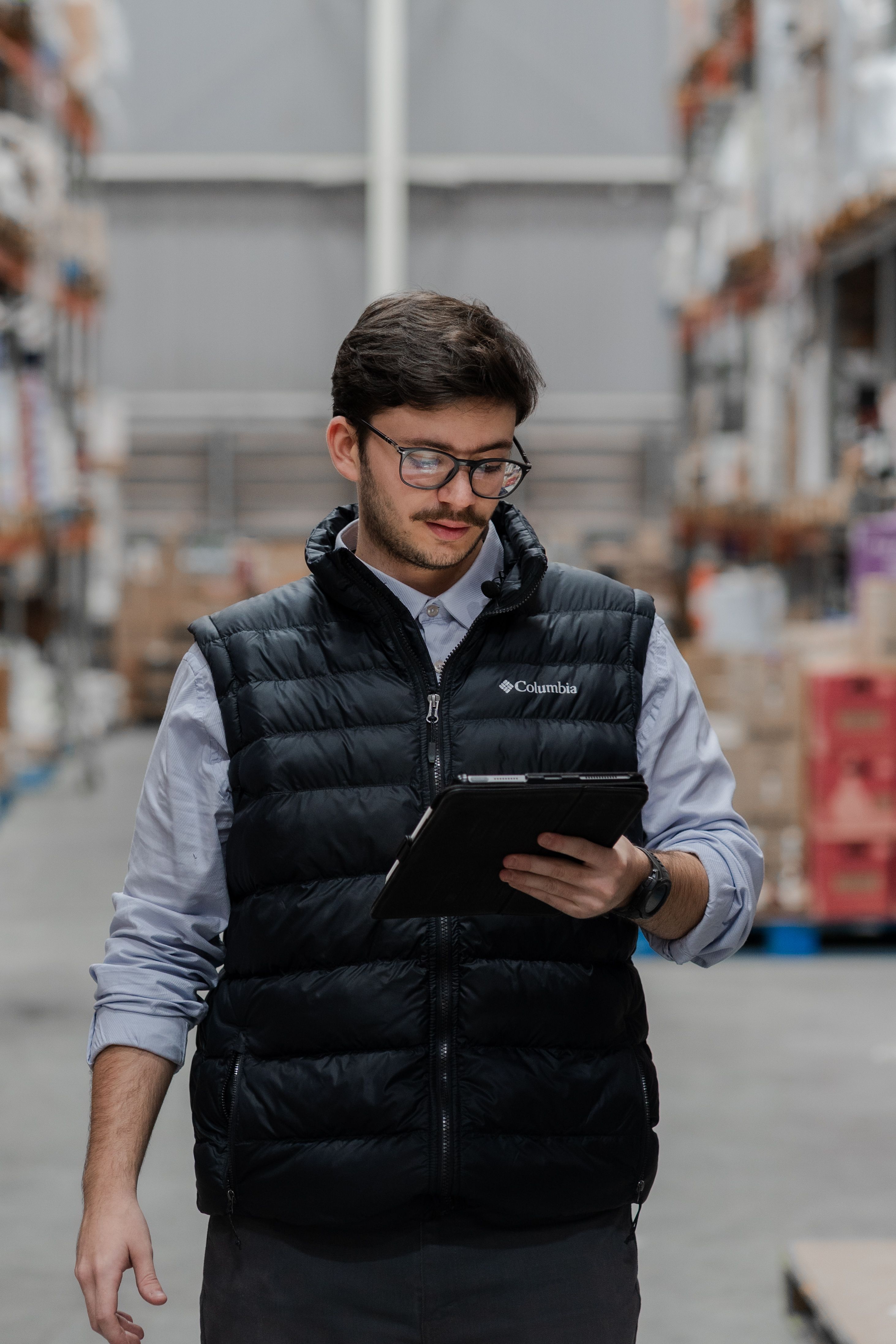A worker checking a module on a tablet